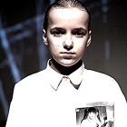 Young boy in white shirt against starry backdrop with surreal face peeling away.