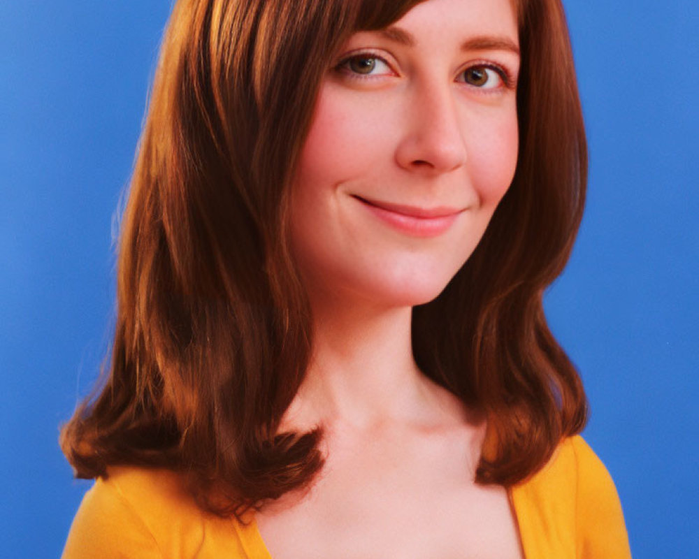 Auburn-Haired Woman in Yellow Top Smiling on Blue Background