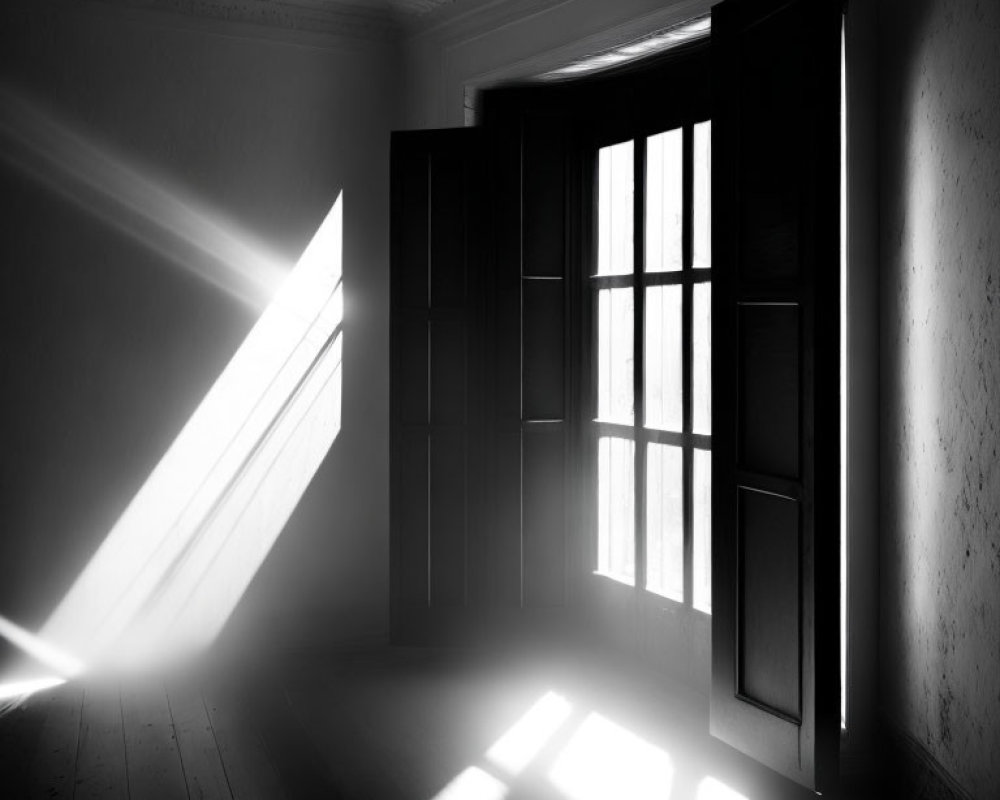 Monochrome image: Sunlight through open door, casting shadows