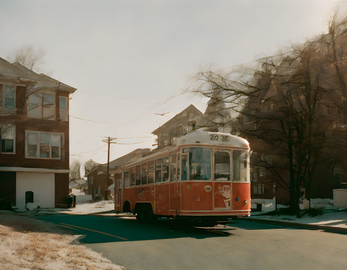 Vintage Orange Streetcar on Snowy Residential Street with Traditional Houses