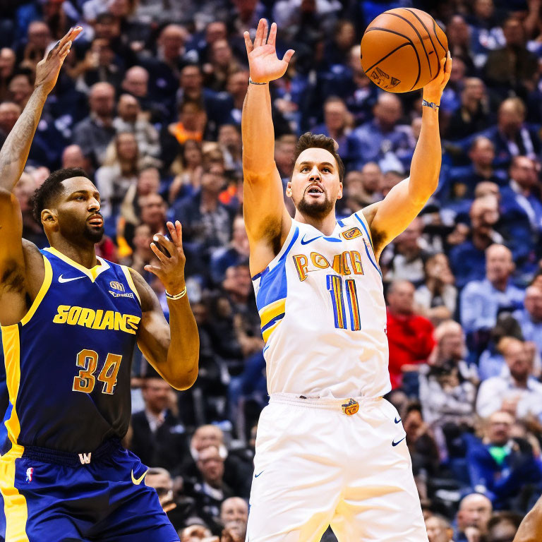 Basketball players in white and yellow vs. blue and gold uniforms in action