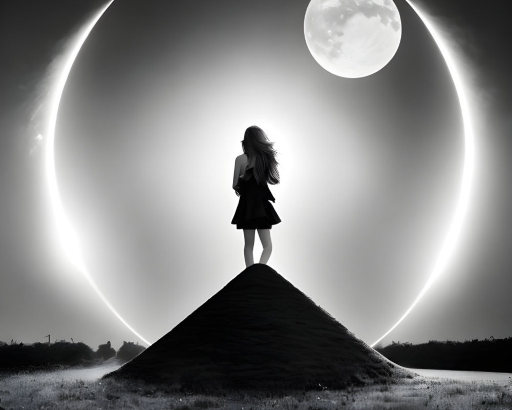 Silhouette of woman under surreal sky with dual moons on hill.