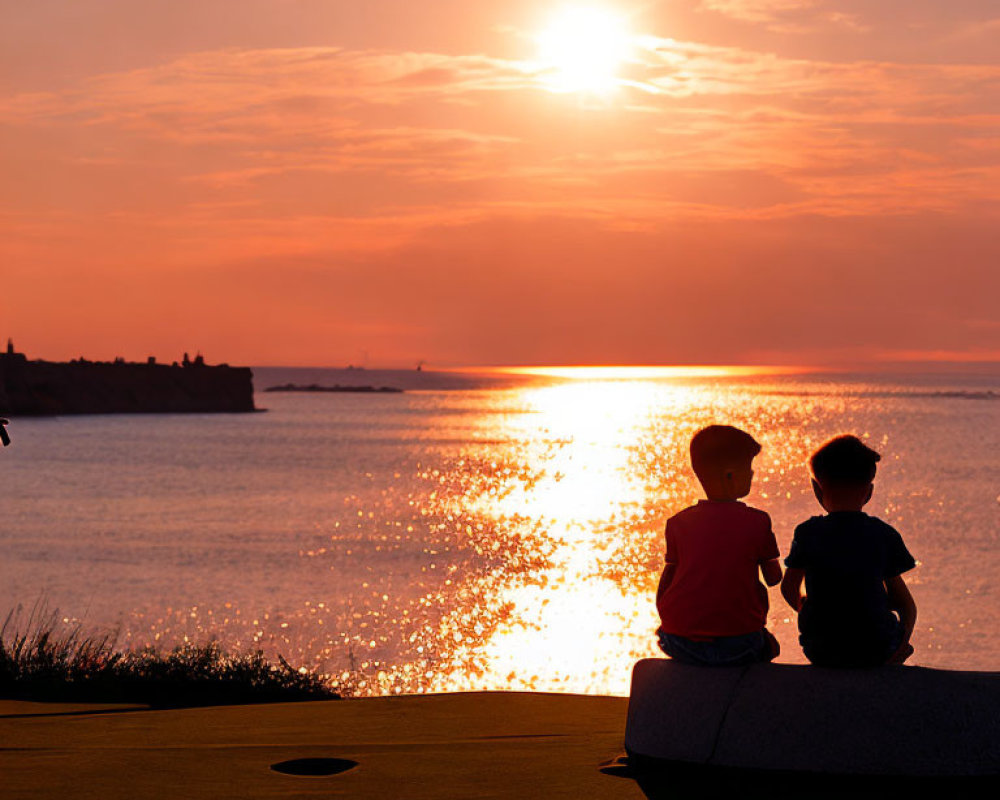 Children enjoying scenic sunset by water's edge