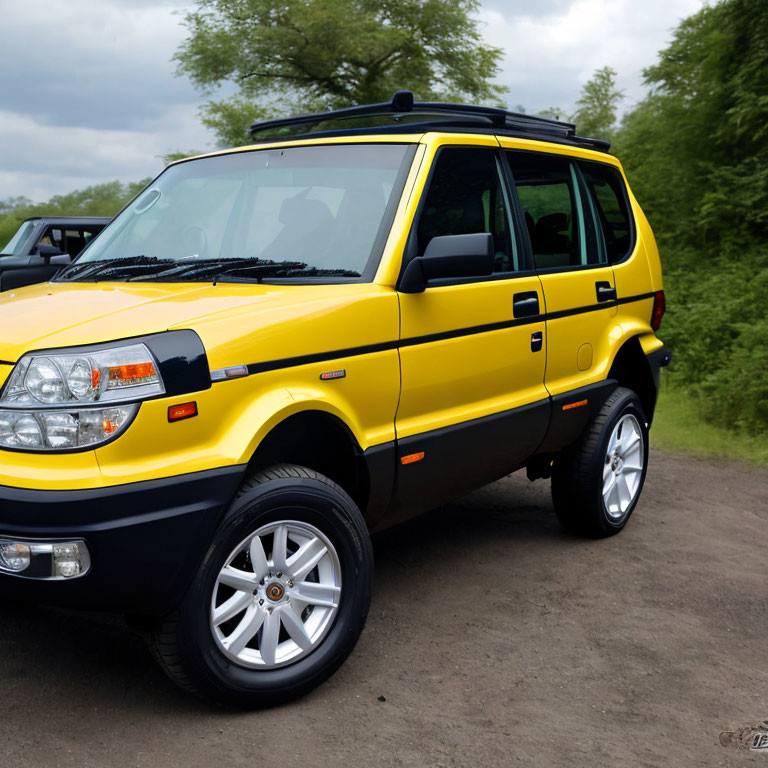 Yellow 4WD SUV with Chrome Wheels and Black Trim Outdoors