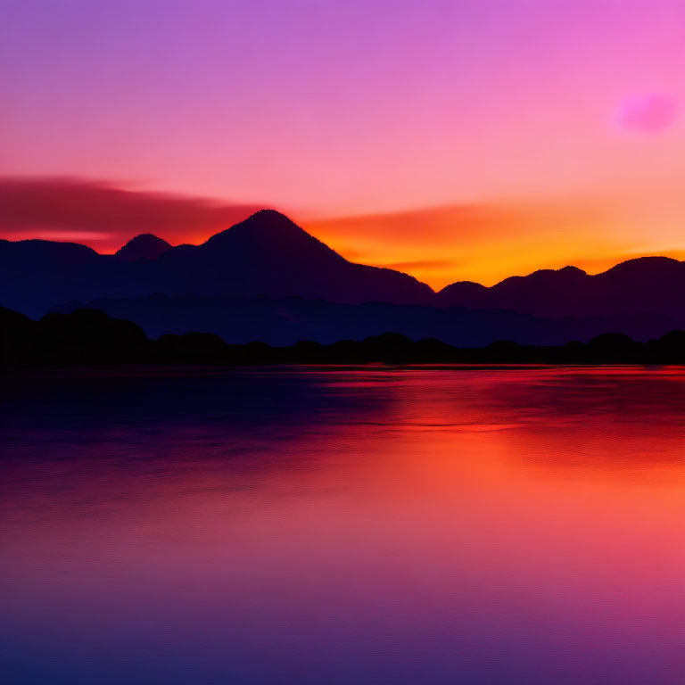 Scenic sunset with purple and orange hues over calm water and mountain silhouettes