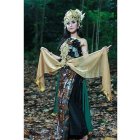 Ethereal woman in fantasy costume with wings in mystical forest setting