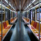 Empty Subway Car with Orange Seats and City Lights at Night