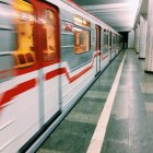 Sleek White Futuristic Train Station with Red Accents and Transparent Walls