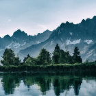 Misty forested mountains reflected on a calm lake at dawn or dusk