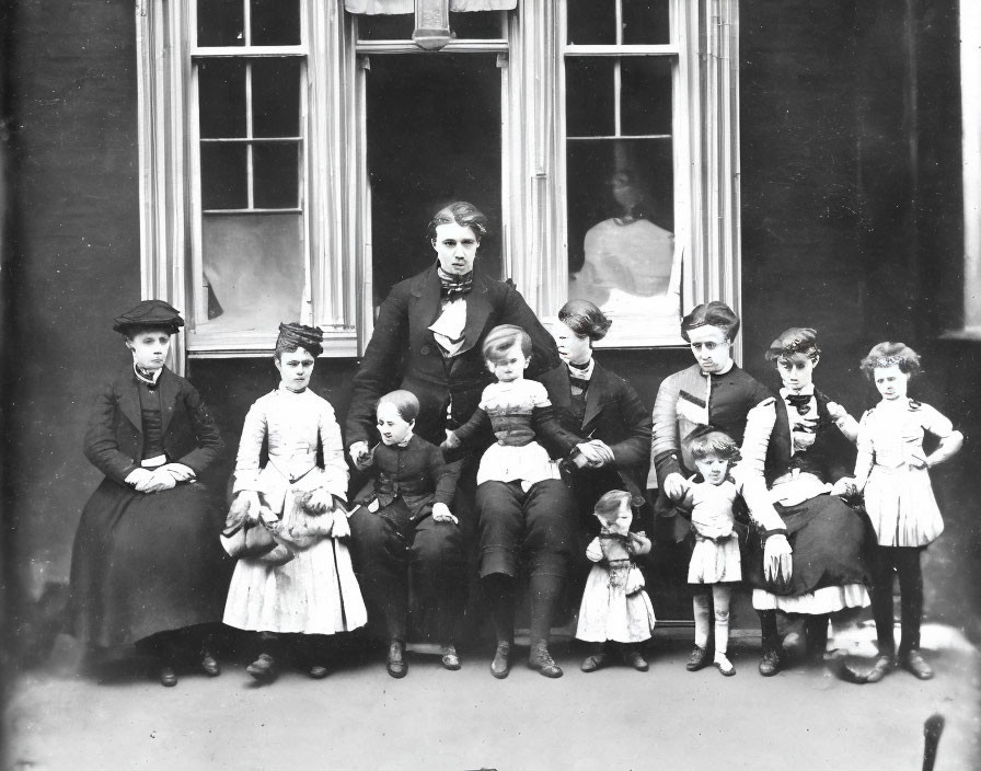 Vintage Black and White Family Photo with Man, Woman, and Children