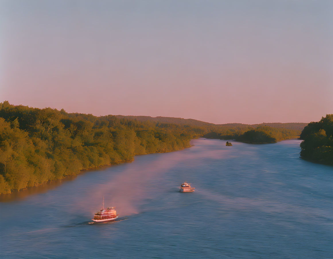 Tranquil river scene at dusk with two boats, lush greenery, and pastel sky