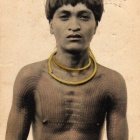 Man in Traditional Tribal Attire with Face Paint