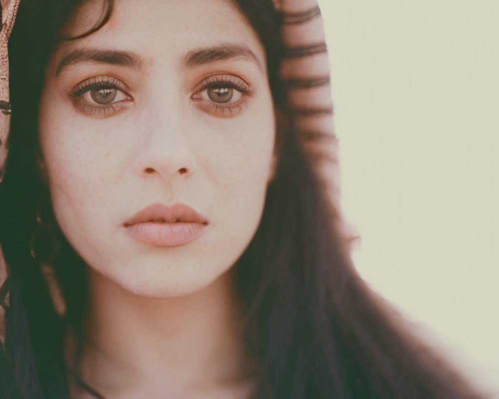 Close-Up Portrait of Woman with Dark Eyes and Hair in Striped Headscarf