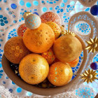 Intricately patterned ornate spheres in warm hues with celestial objects and blue bubbles.