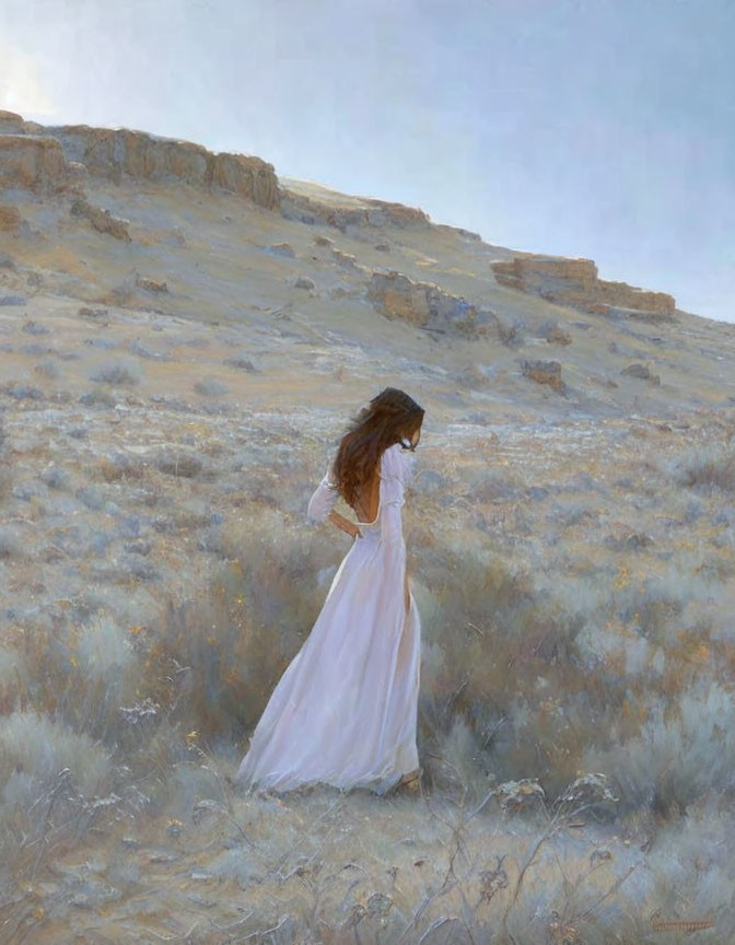 Woman in white dress walking through serene desert landscape