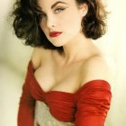 Portrait of Woman with Dark Curly Hair, Red Berries, and Off-the-Shoulder Dress