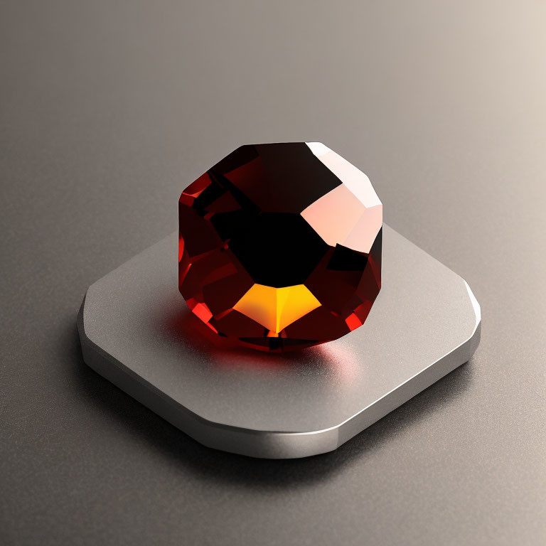 Faceted red gemstone on grey pedestal with soft reflections