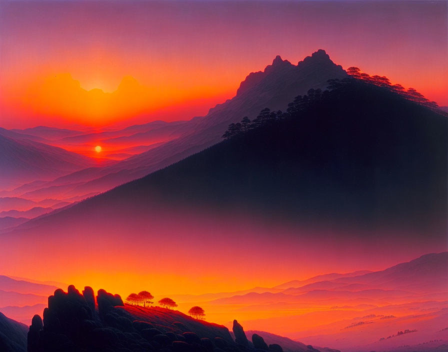 Vibrant sunset over mountain range with silhouetted peaks