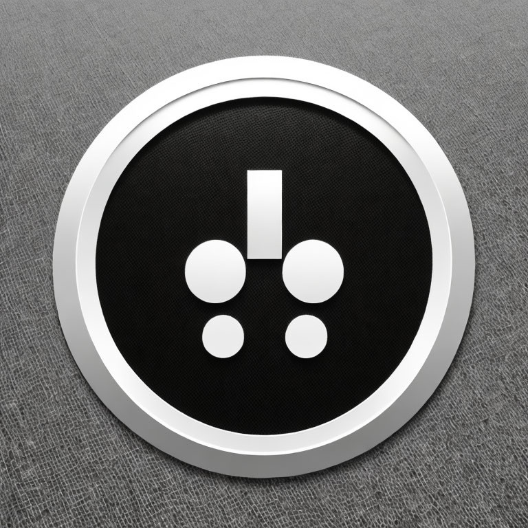 Silver-framed round button with black center and exclamation mark connected to dots