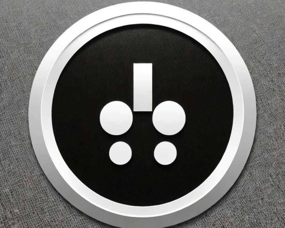 Silver-framed round button with black center and exclamation mark connected to dots