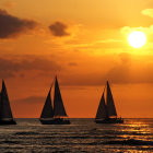 Ocean sunset with sailing ships and vibrant orange sky