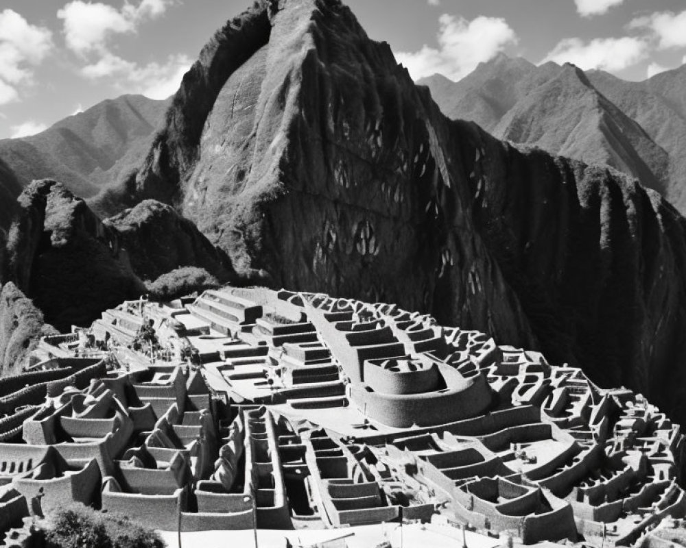 Monochrome photo: Machu Picchu ruins with Huayna Picchu mountain under sky