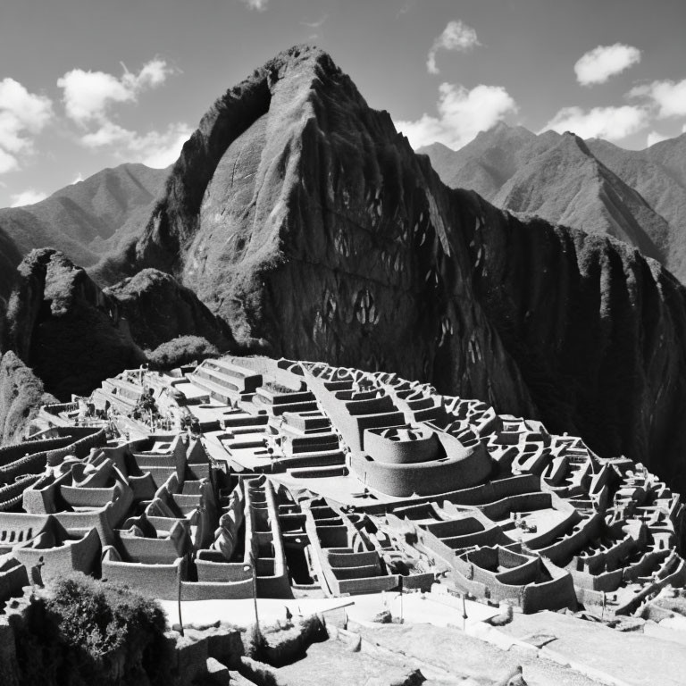 Monochrome photo: Machu Picchu ruins with Huayna Picchu mountain under sky