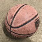 Textured basketball with flamed pattern on wet sandy surface