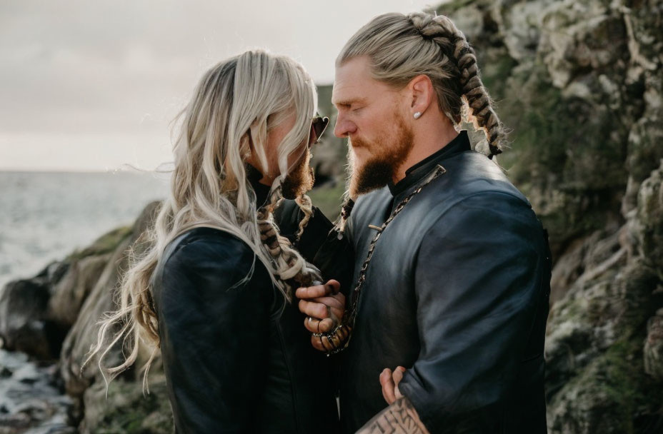 Couple with Braided Hair in Viking-Inspired Leather Outfits by Seaside Cliffs