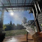 Sunshine casting rainbow on garden tools under corrugated roof