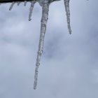 Colorful Glittery Icicles Reflecting on Cloudy Sky