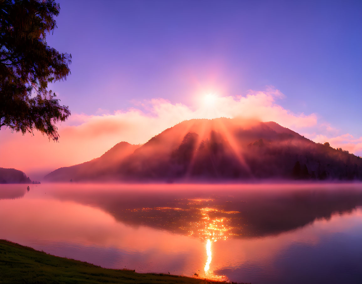 Tranquil lake sunrise with fog, mountains silhouettes