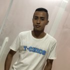 Confident young man in white t-shirt against soft-focus background