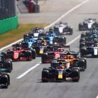 Three Purple Formula 1 Cars Racing on Misty Dusk Track