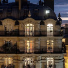 Ornate Parisian Building with Flowers and Twilight Sky