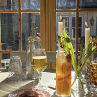 Candlelit cozy scene with pie and glassware by window overlooking twilight castle landscape