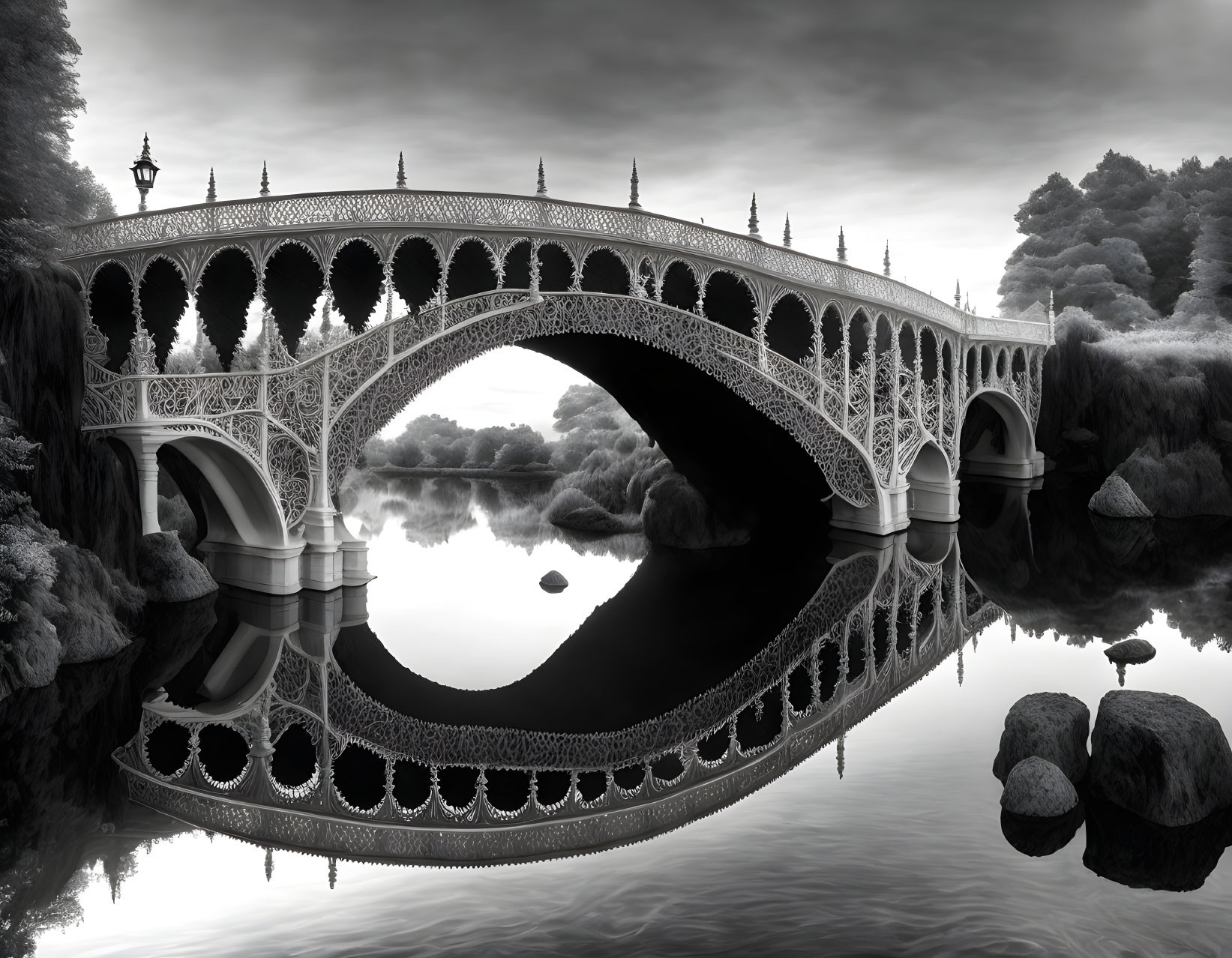 Intricate arched bridge over calm river in black-and-white landscape