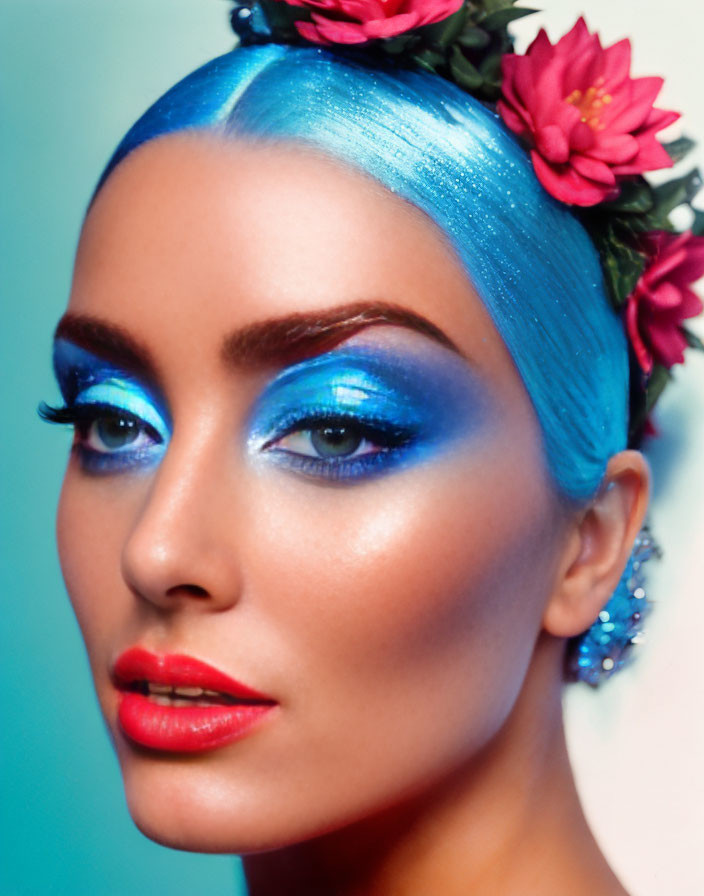 Vibrant woman with blue eyeshadow, glittery hair, red flowers, and red lipstick