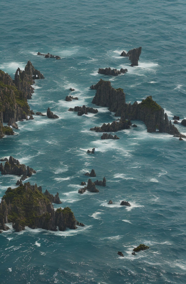 Dramatic rugged cliffs against turbulent ocean waves