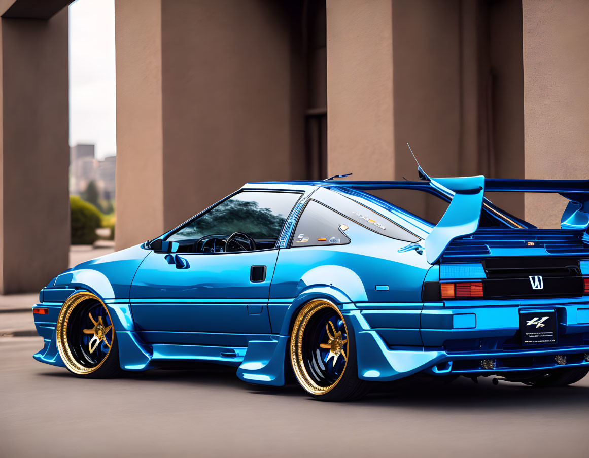 Customized blue Honda CRX with gold rims in urban setting