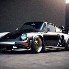 Black Porsche with Rear Spoiler & Chrome Rims in Dimly Lit Setting