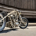 Custom skeletal design motorcycle against wooden wall