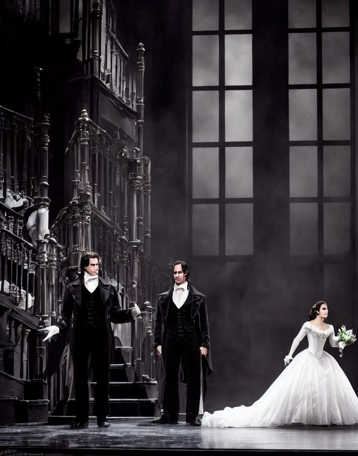 Three performers in formal attire on grand staircase with large windows