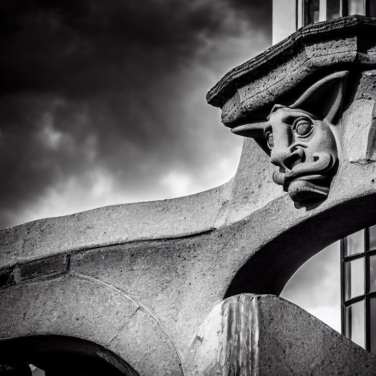 Monochrome architectural sculpture featuring stylized face on building.