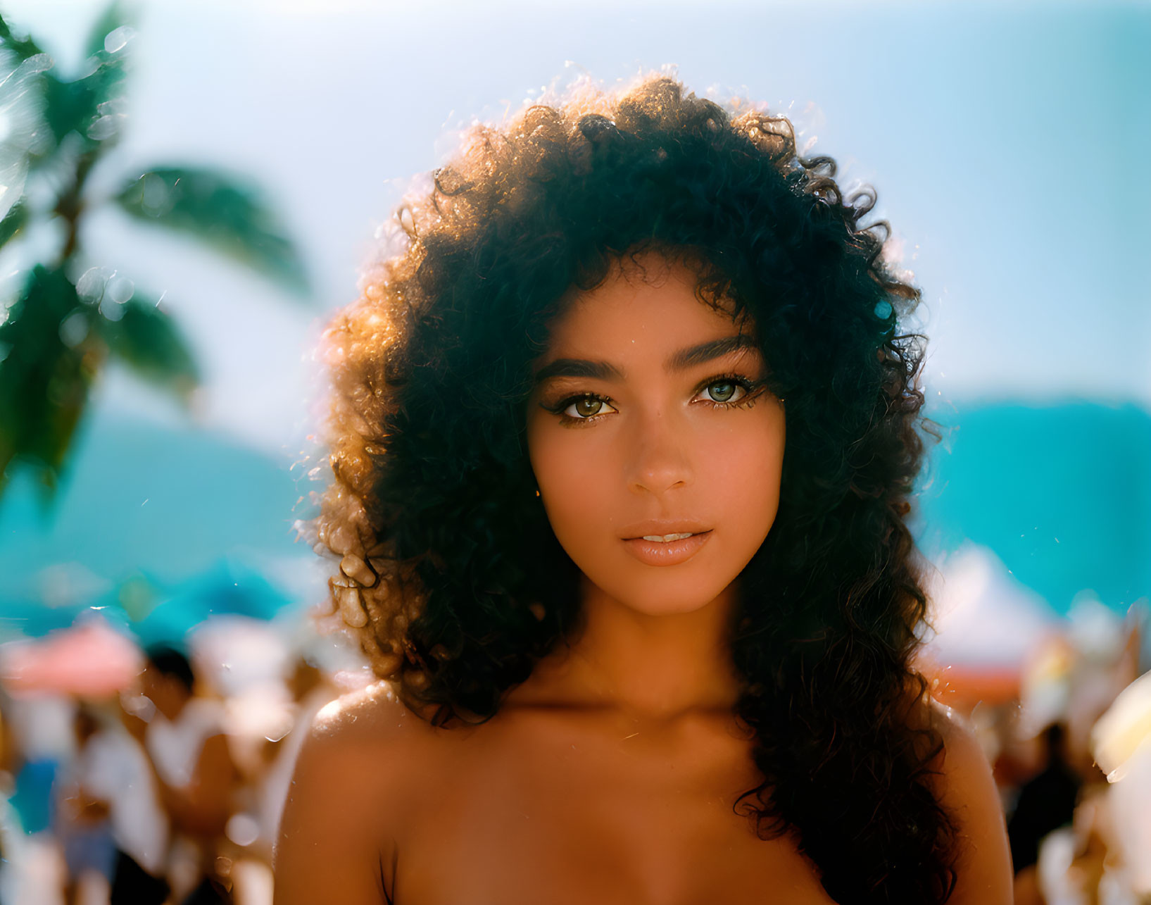 Curly-Haired Woman with Striking Eyes Outdoors in Sunlit Setting