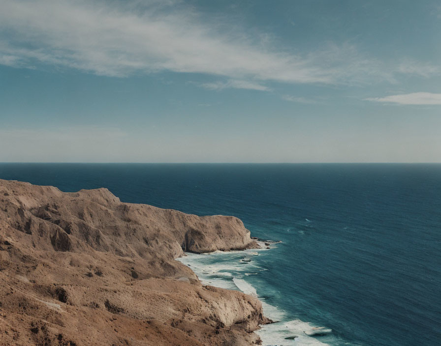 Scenic rugged coastline with steep cliffs and calm blue sea