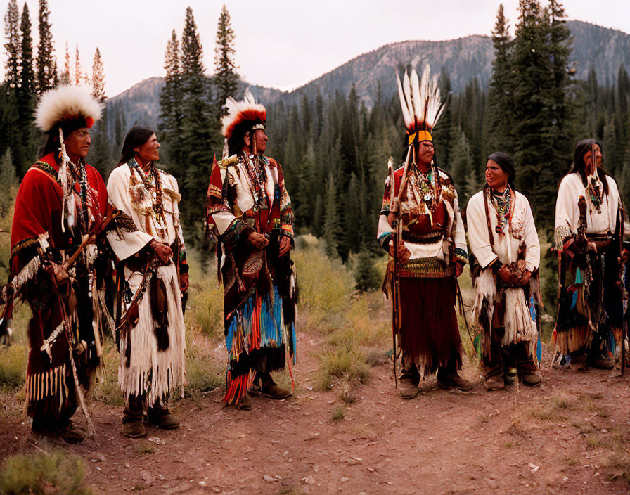 Native American group in traditional attire in forest clearing