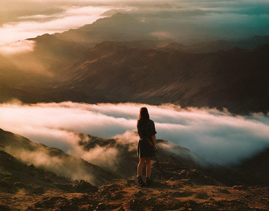 Person on Mountain Vista at Sunset with Misty Landscape