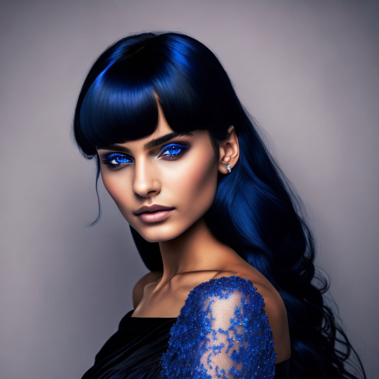 Vibrant blue-haired woman with striking blue eyes and sequined shoulder detail