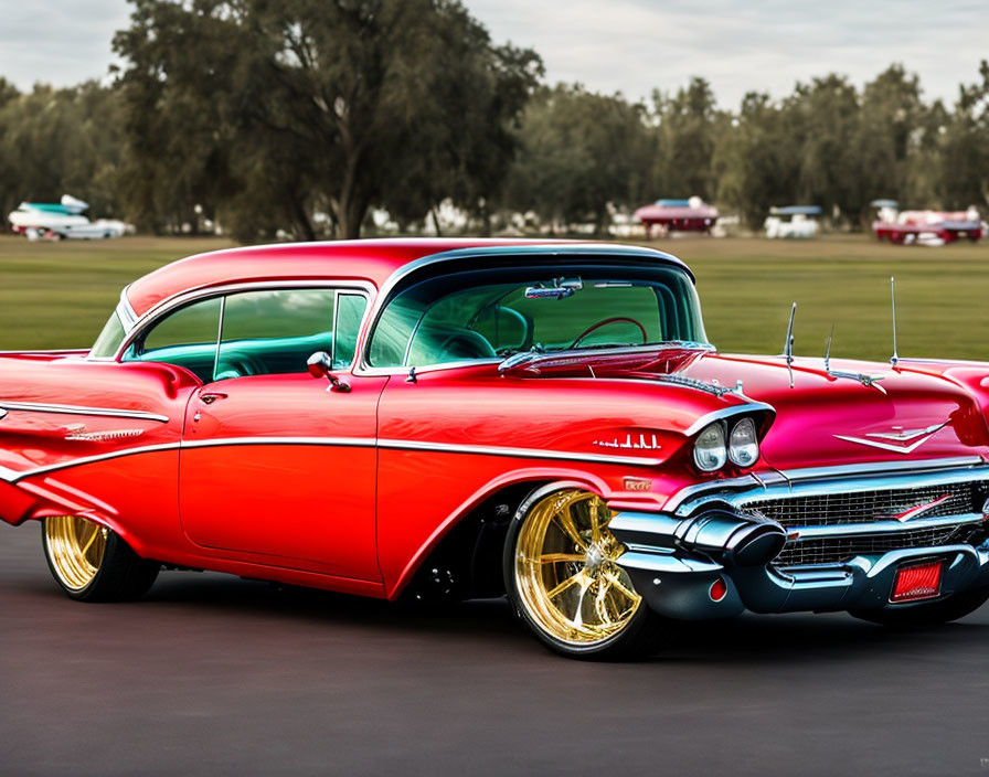 Vintage Red and White Two-Tone Car with Gold Rims and Tailfins